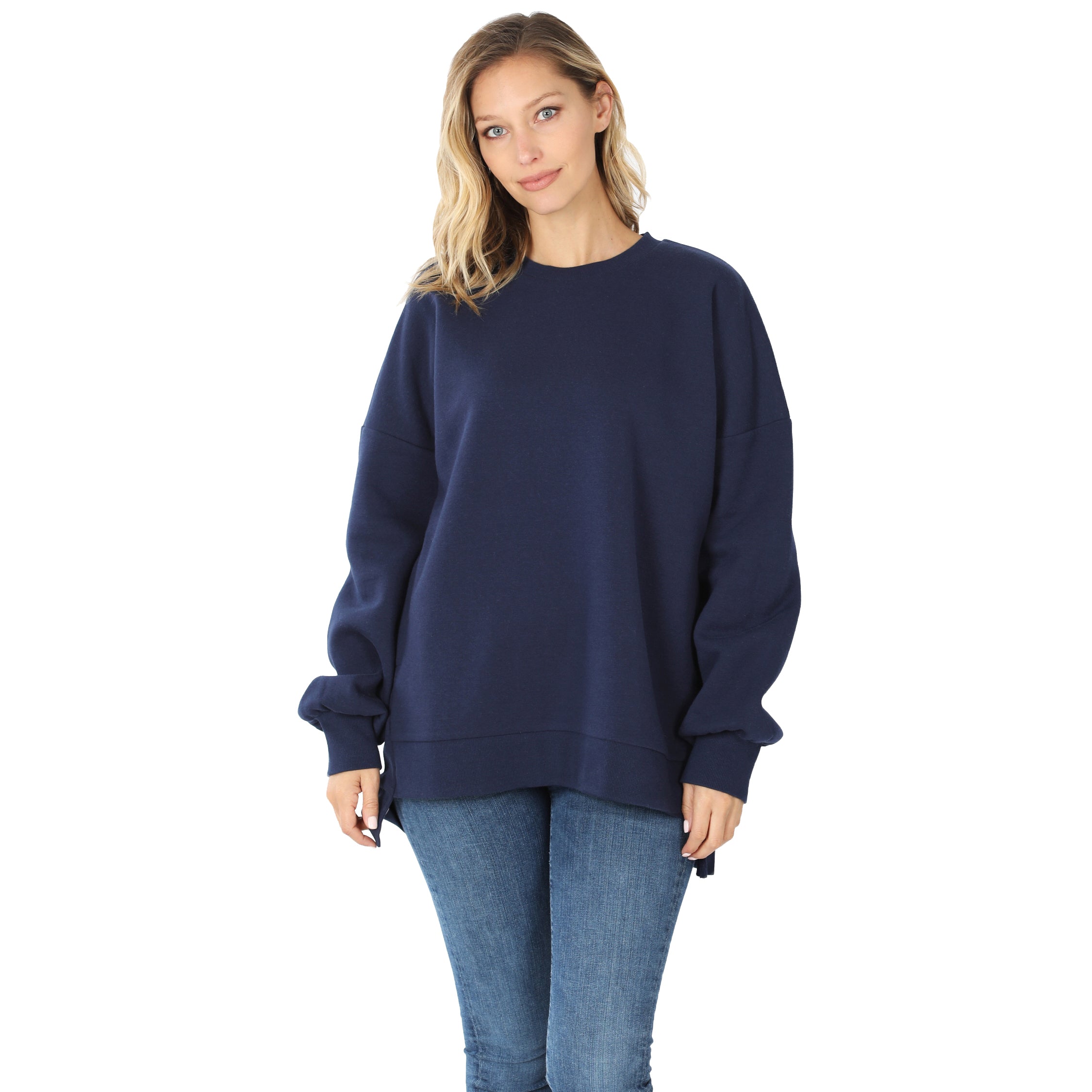 Woman wearing a navy blue sweatshirt and jeans on a white background