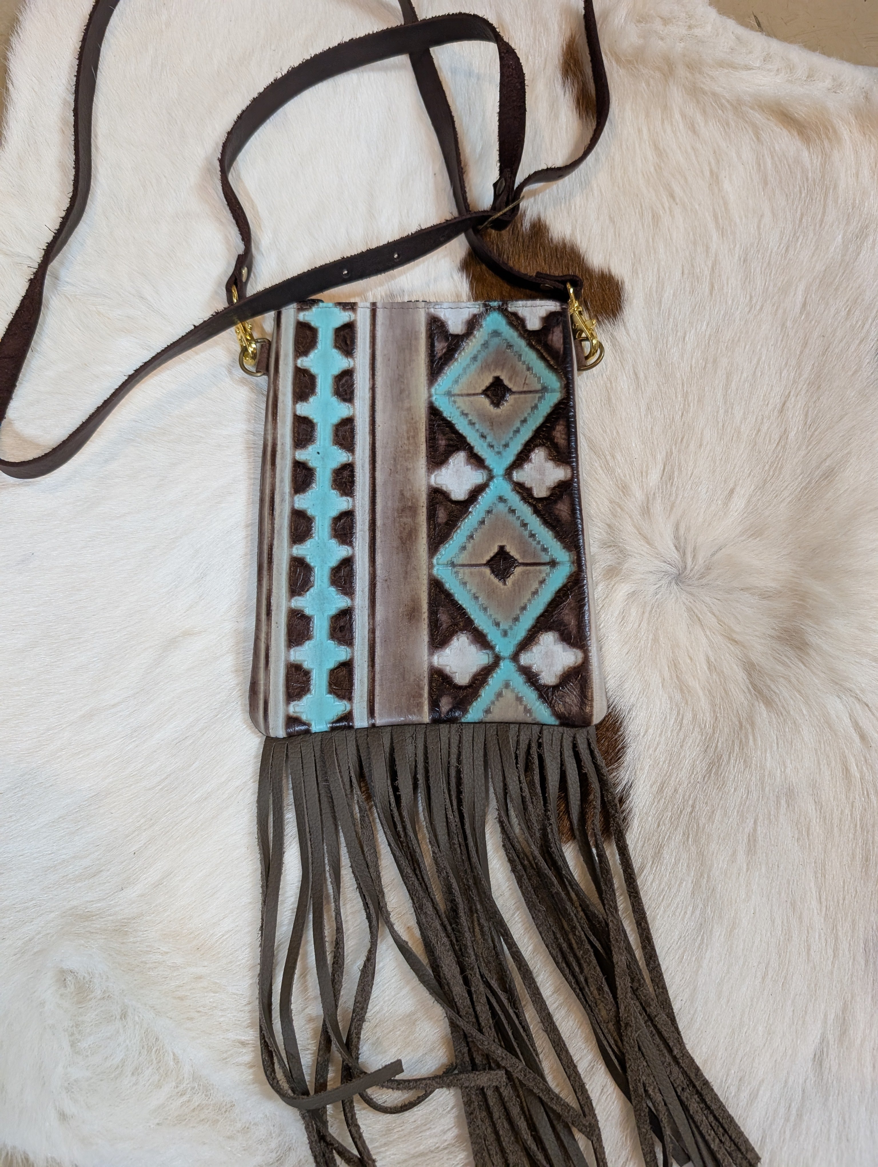 Fringe bag with tribal pattern on a fur surface