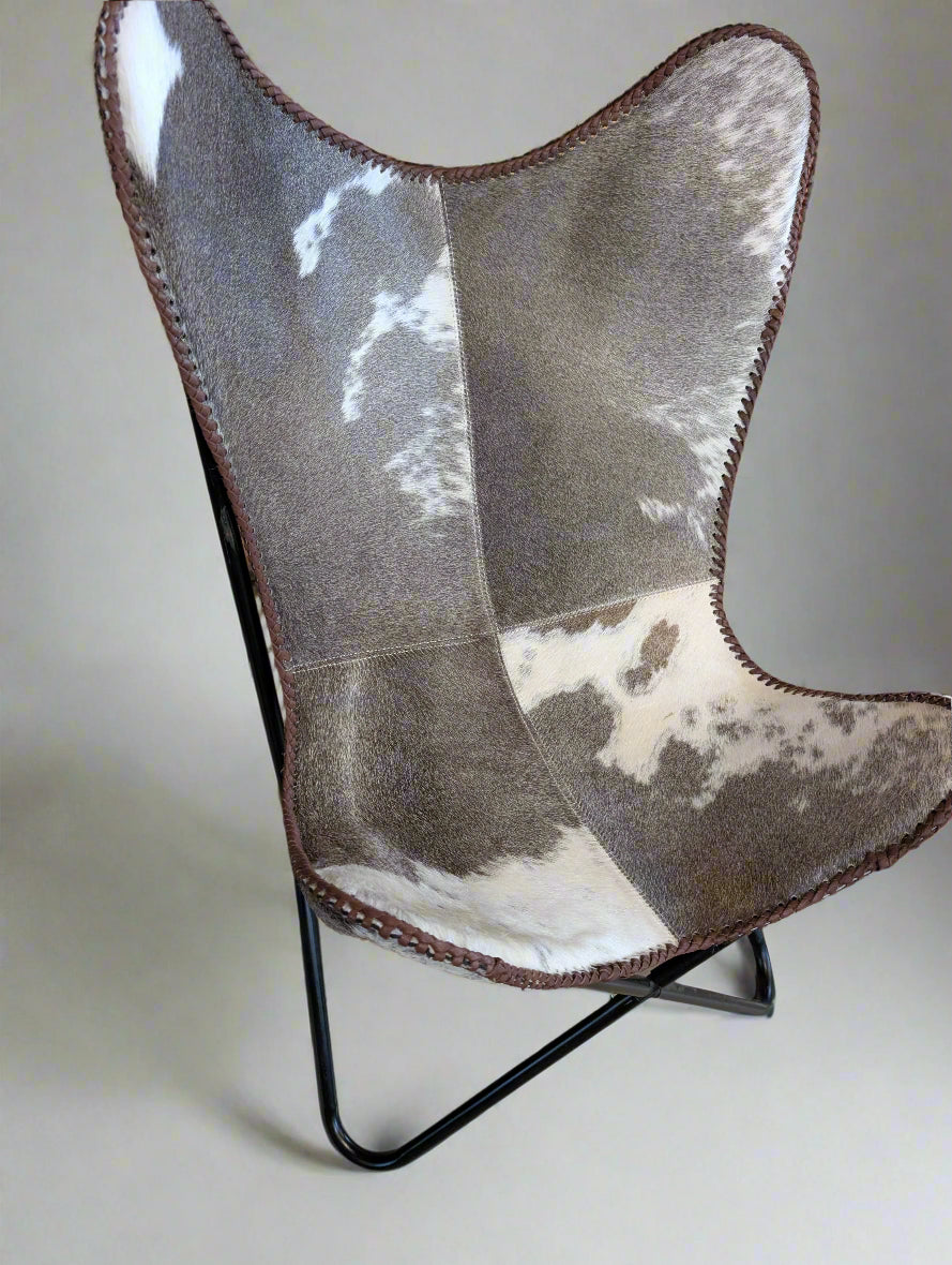 Rustic western cowhide chair featuring unique hide patterns and disassemblable frame for easy transport or storage.