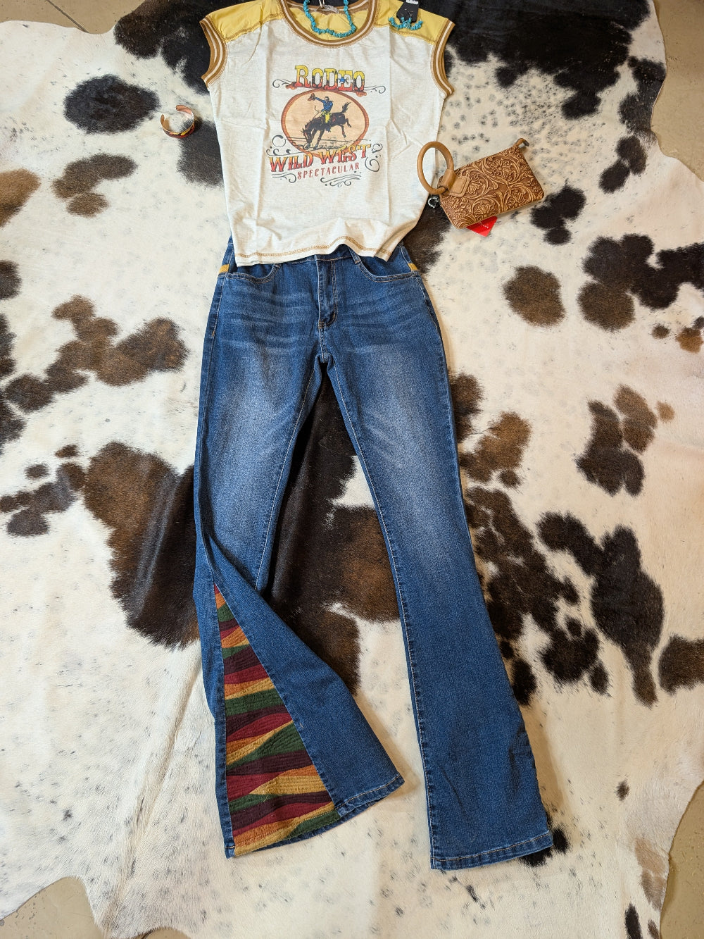 Delila women’s mineral wash Wild West graphic tee in grey tones, displayed flat on cowhide rug