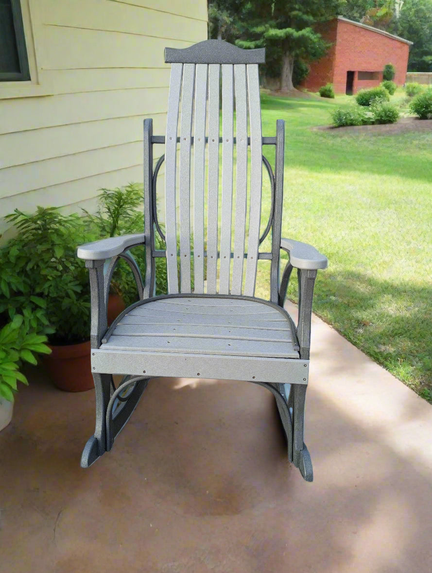 Gray poly rocking chair on a concrete surface with a blurred natural background