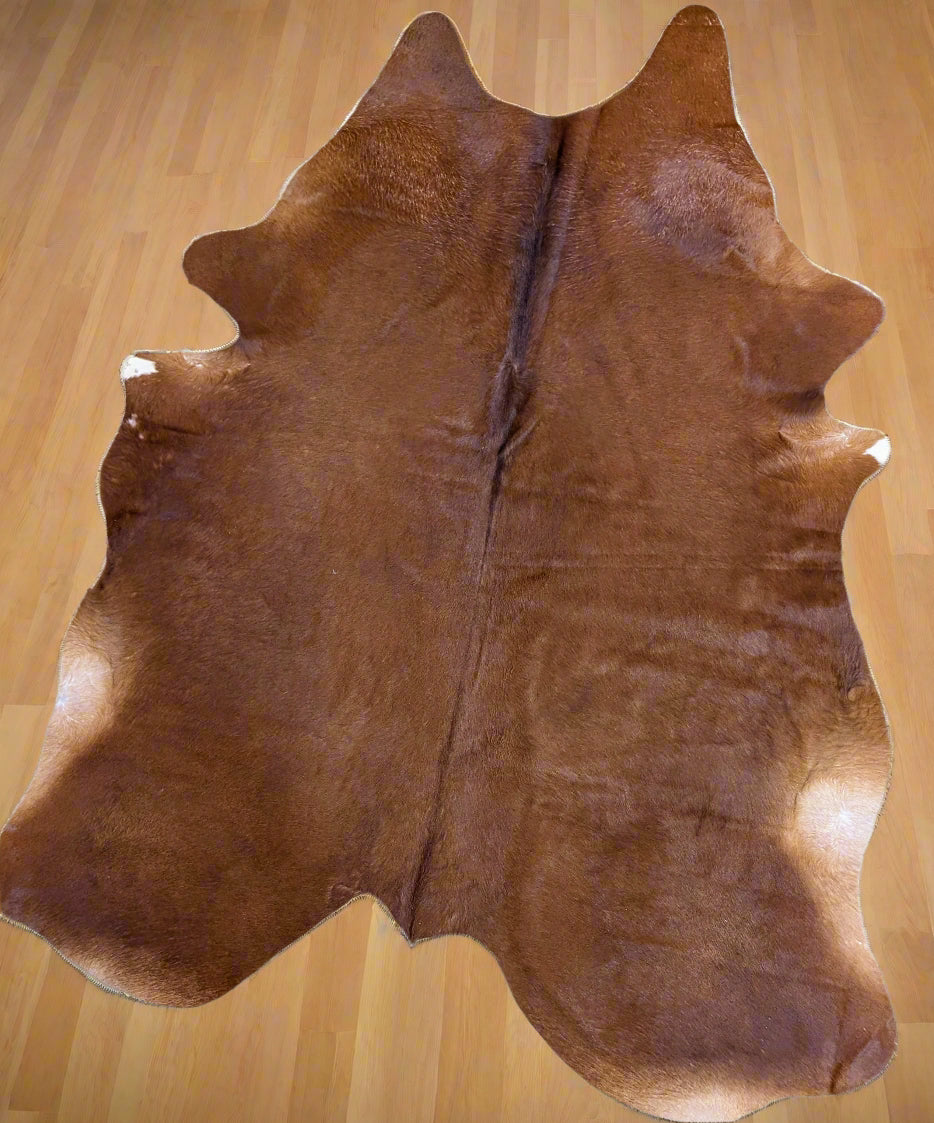 Genuine red cowhide rug with natural texture and rich color