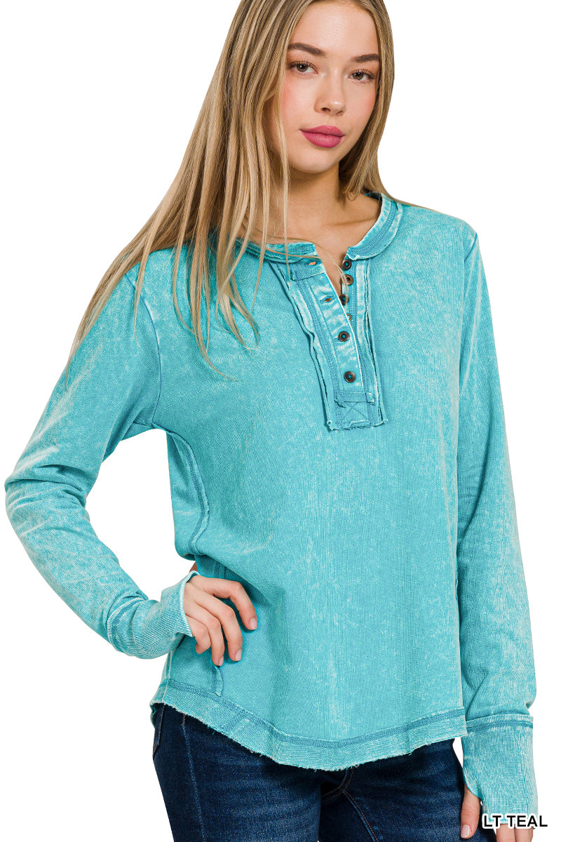 Woman wearing a teal long-sleeve shirt with buttons on a white background