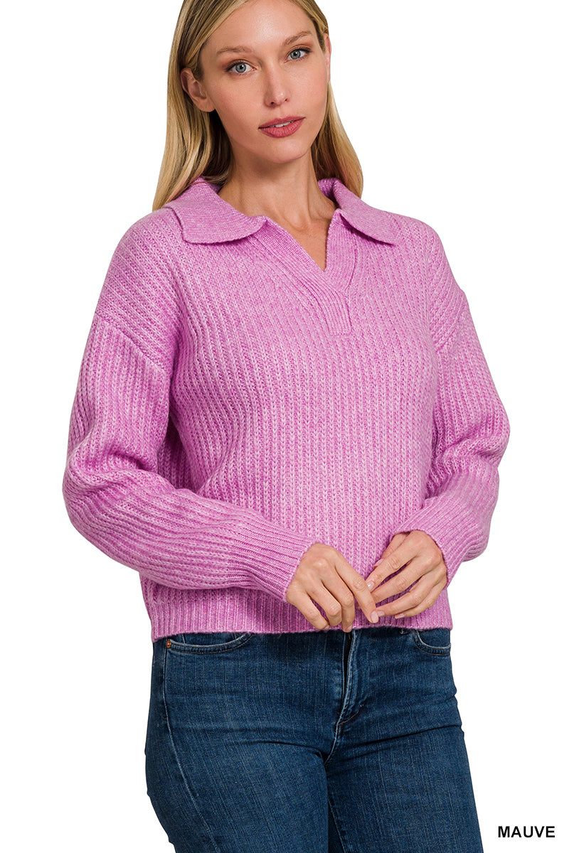 Woman wearing a pink sweater with a collar on a white background