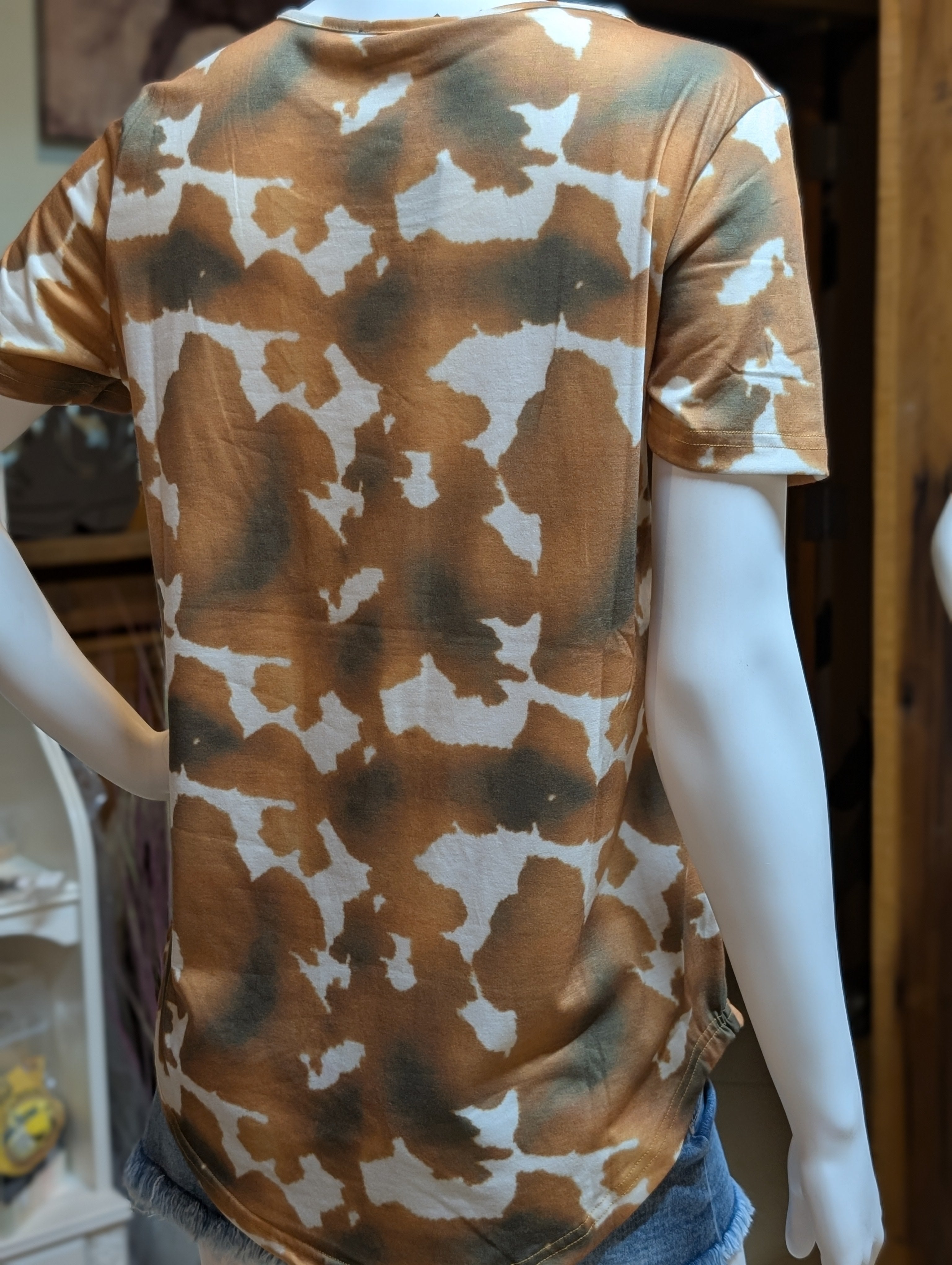 Trendy short sleeve cow pattern top for women, perfect for casual or rodeo-inspired outfits