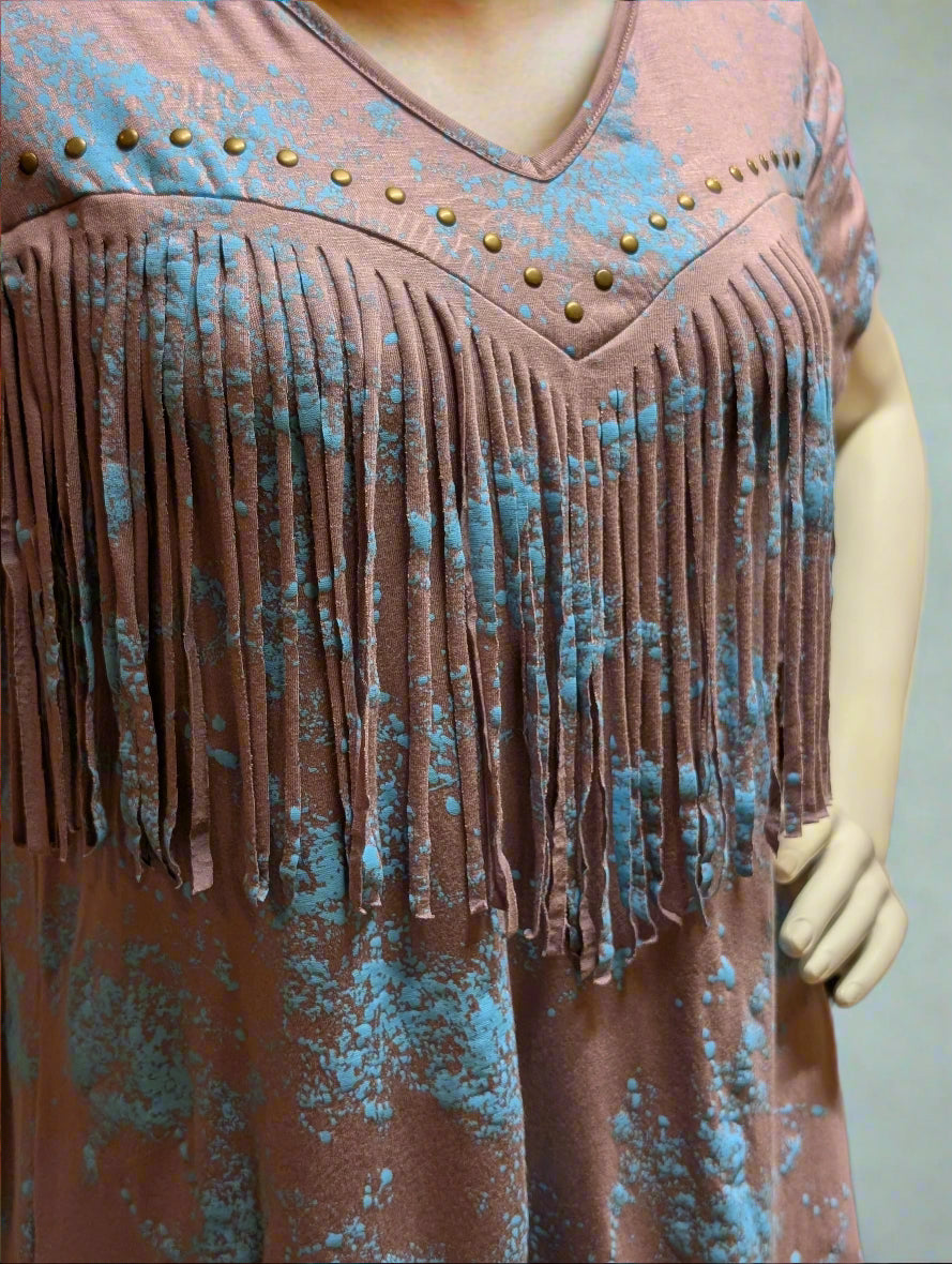 Woman wearing Vocal Western V-neck fringe top with stud detail in lavender, styled with denim and boots for a rodeo look.