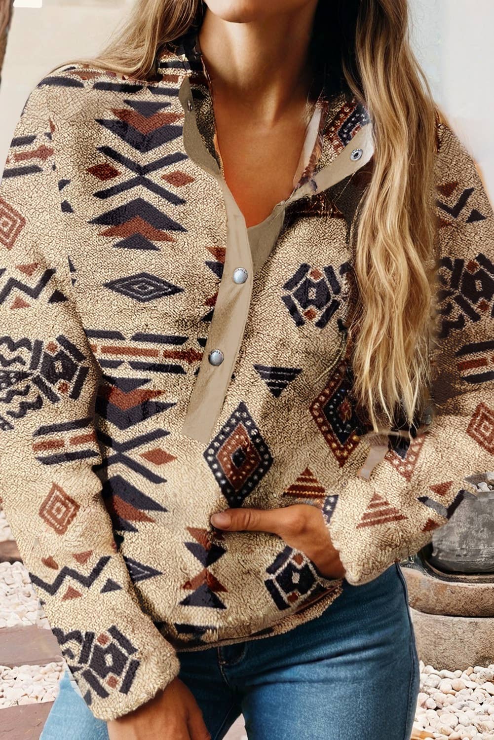 Person wearing a patterned fleece jacket outdoors