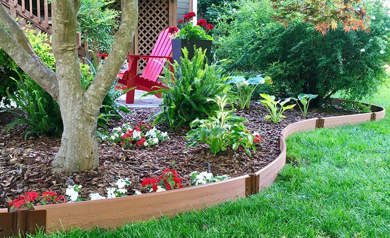 Outdoor photo with flowers and tree.