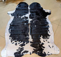 Black and white cowhide rug on a tiled floor
