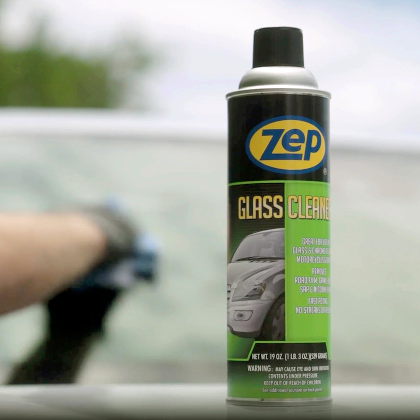 Zep glass cleaner can with a blurred car in the background