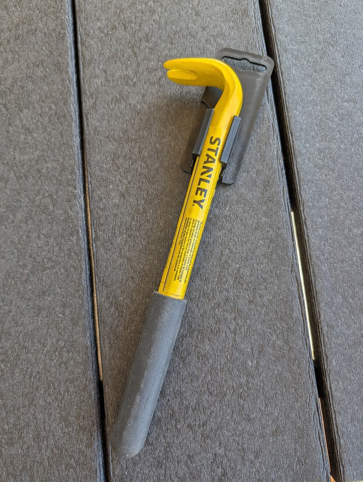 Yellow and gray tool on a textured surface