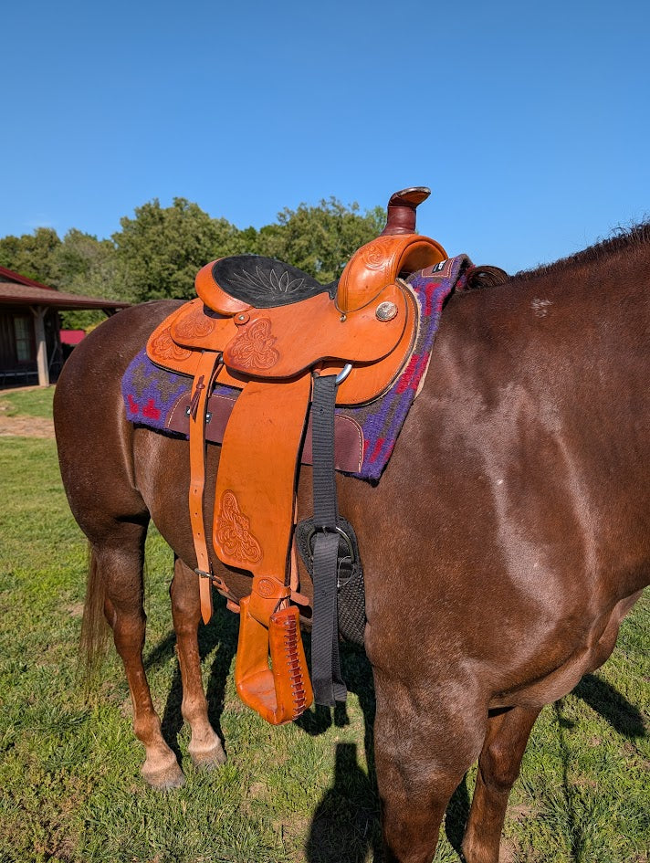 Leather roping saddle on a horse.
