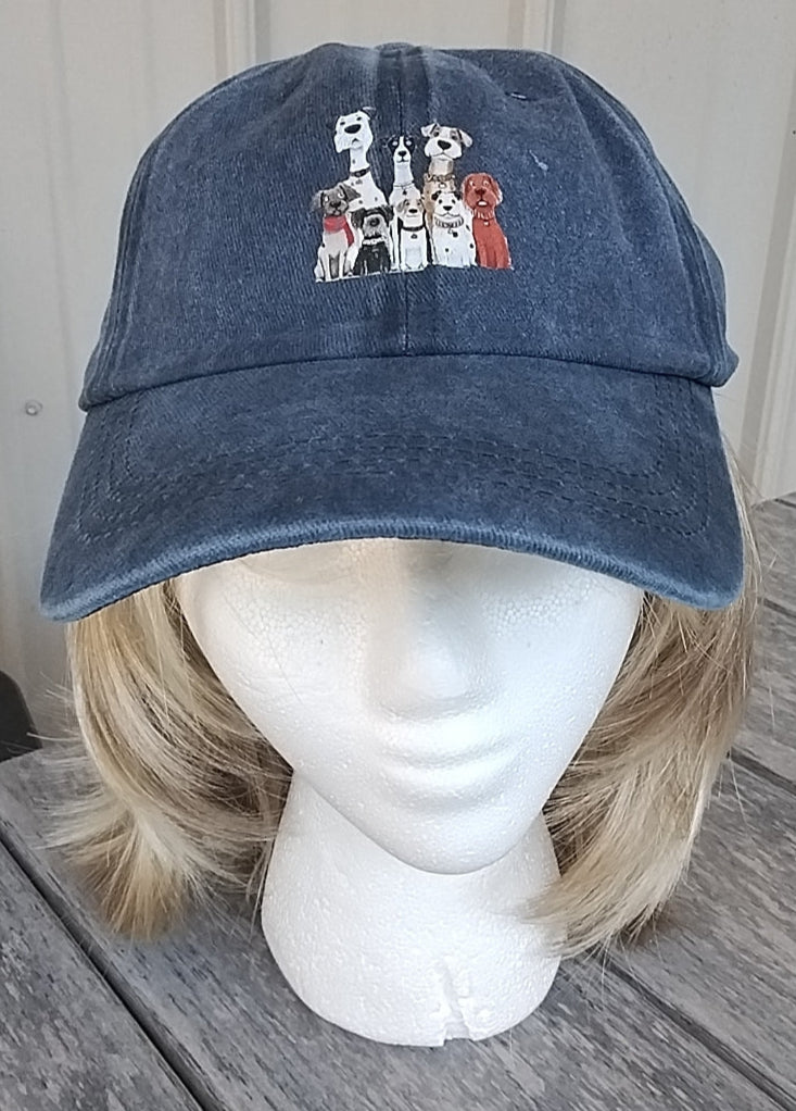 Blue denim cap with embroidered designs on a mannequin head against a neutral background