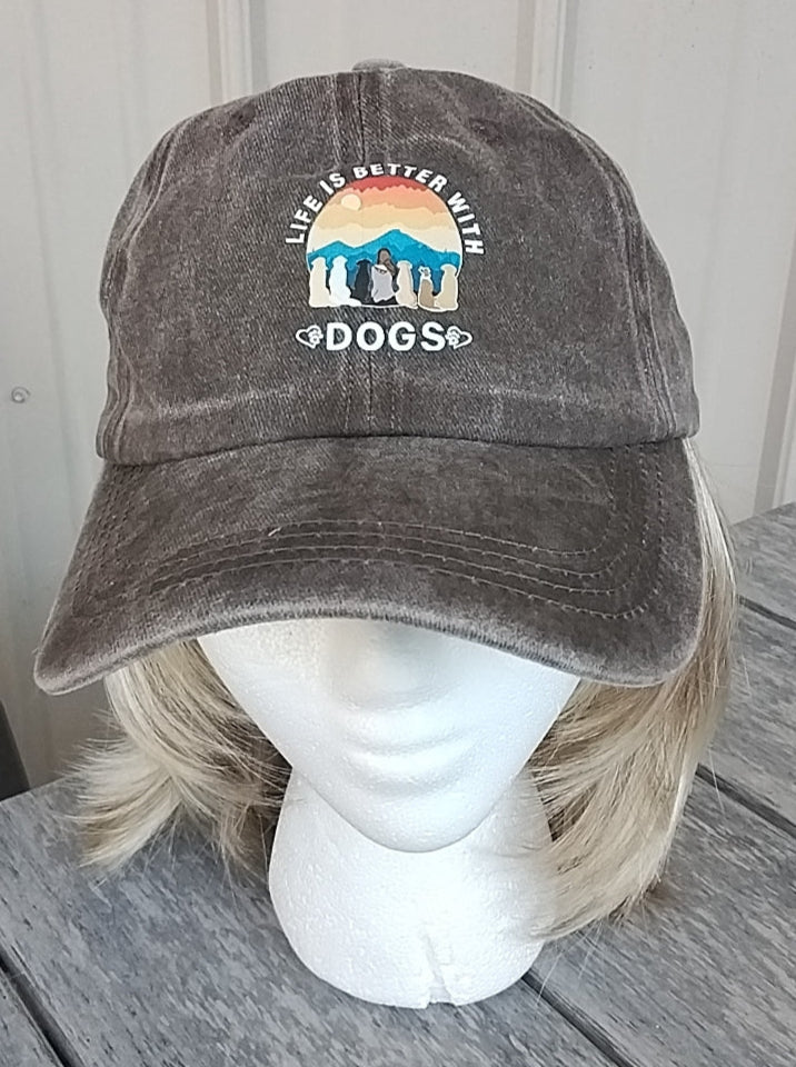 Gray cap with 'Life is better with dogs' design on a mannequin head against a wooden background