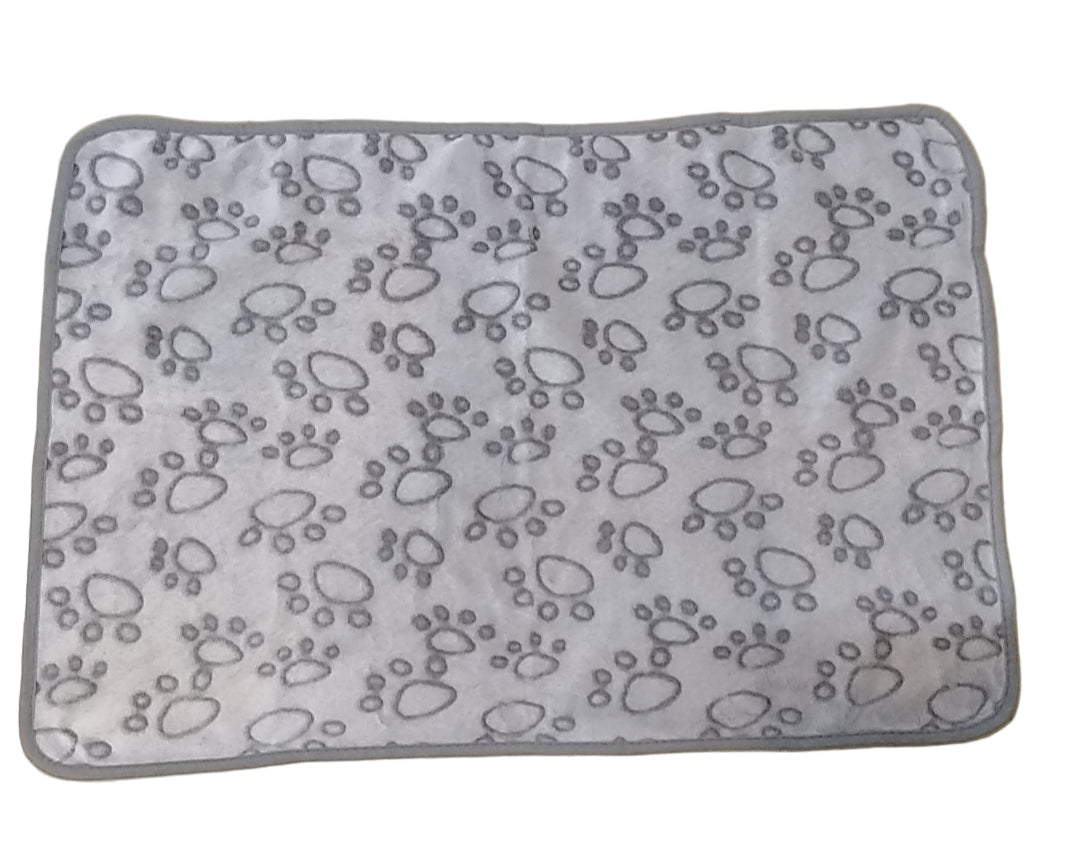 Gray mat with paw print pattern on a beige floor