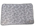 Gray mat with paw print pattern on a beige floor