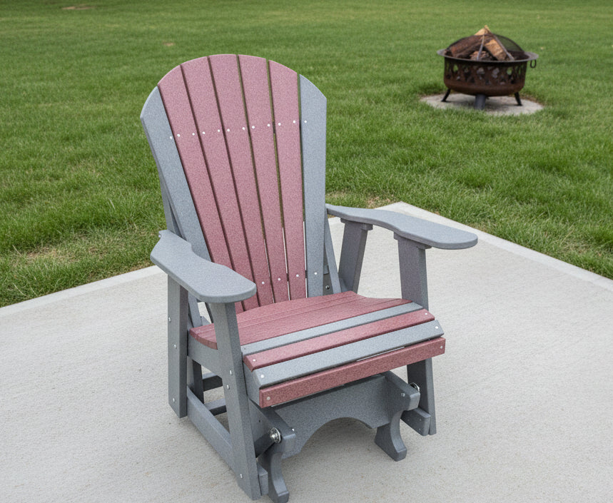 Gray and Red Poly Glider on a concrete pad with a firepit in the background