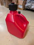 Red fuel container with black cap on a tiled floor