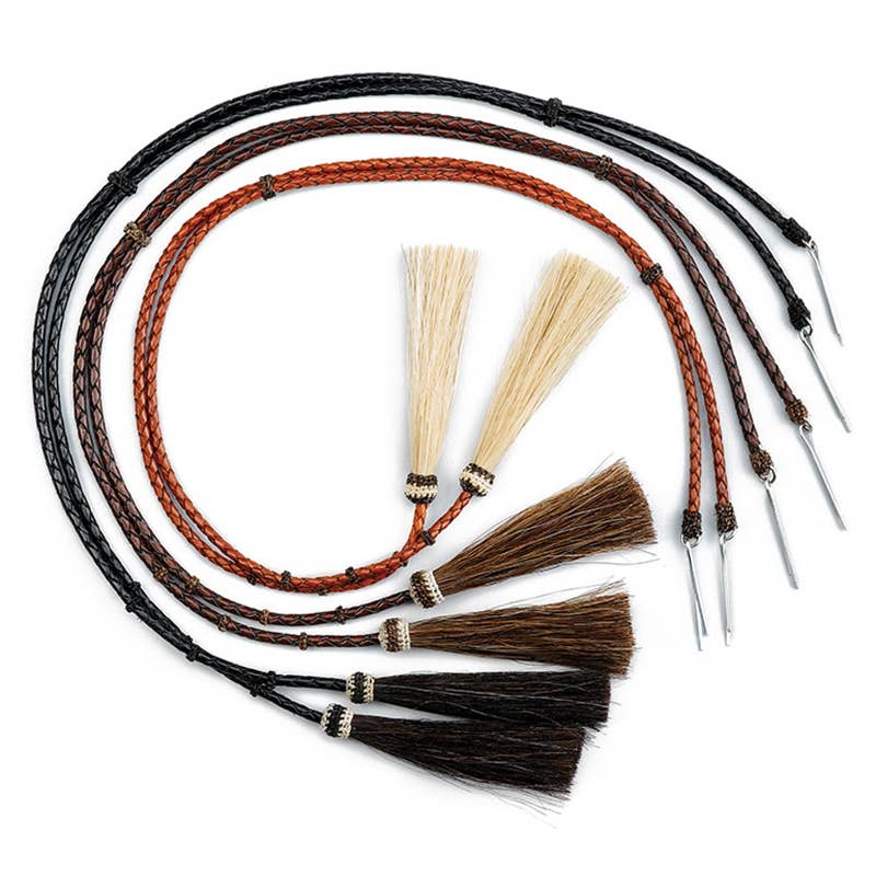 Set of horse whips with braided handles and natural horsehair tassels on a white background
