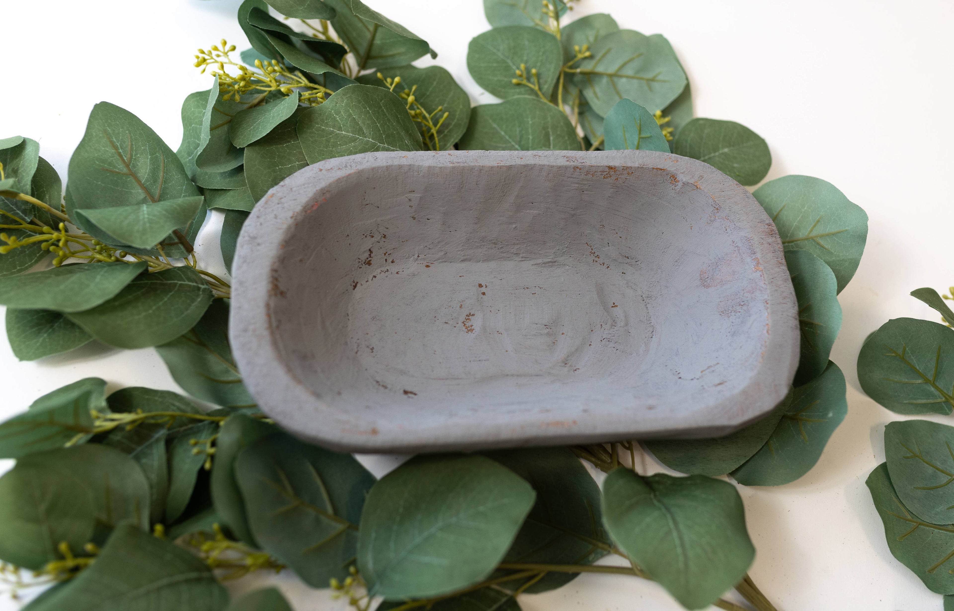 Small farmhouse-style wood bowl on vintage linen