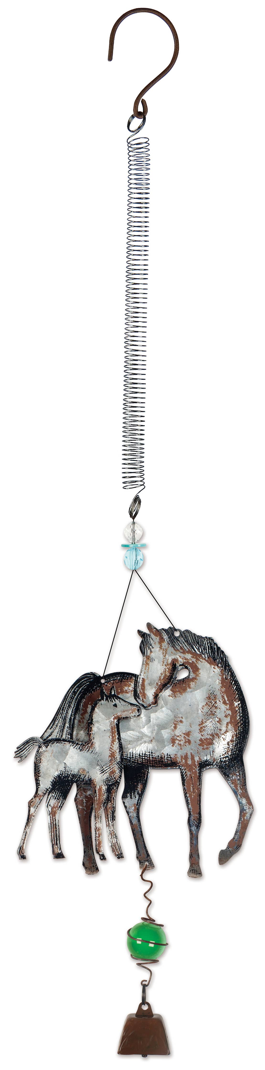 A rustic metal hanging ornament featuring a mother horse and foal design with a coiled spring, small blue bead, green bead, and brown bell at the bottom.