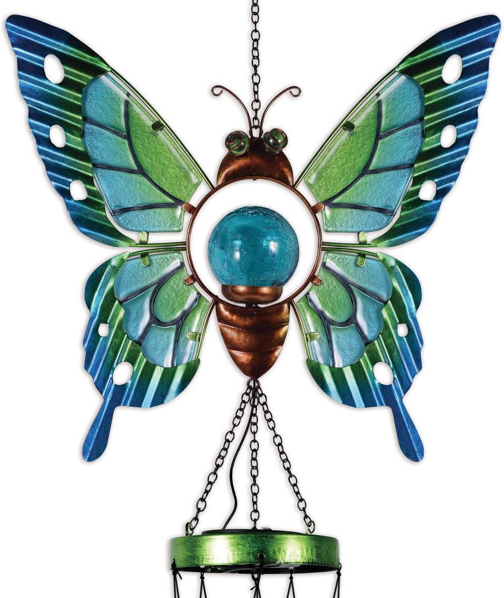Decorative butterfly with blue and green wings and a hanging design on a white background