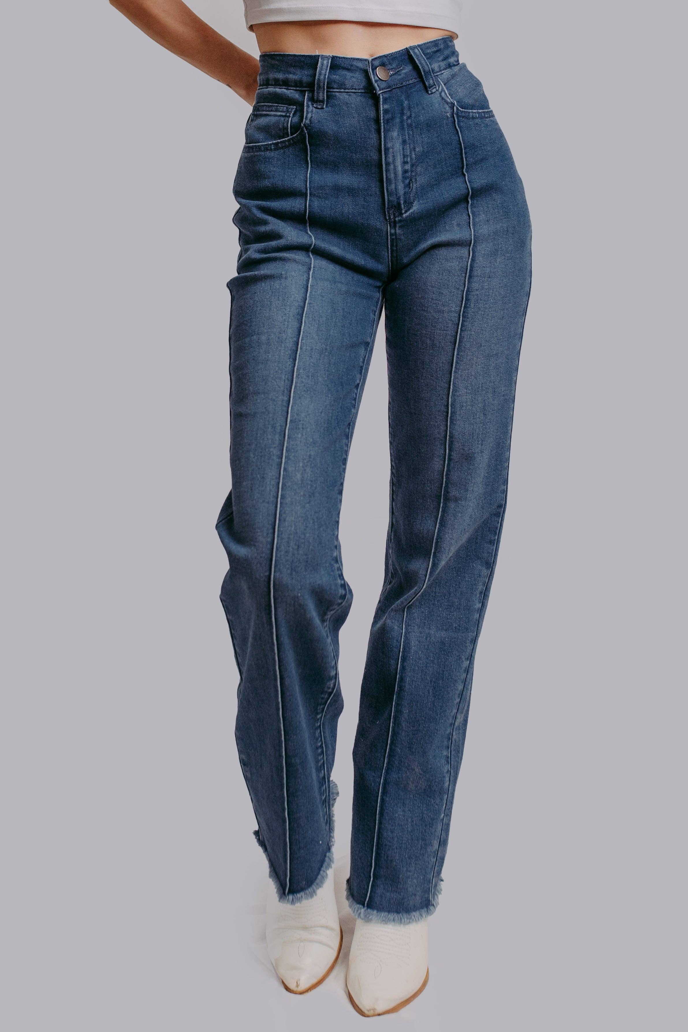 Blue jeans worn by a person on a gray background