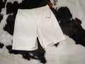 White tailored shorts mid-thigh front view