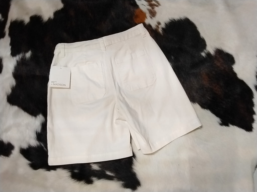 White tailored shorts mid thigh Rear view.