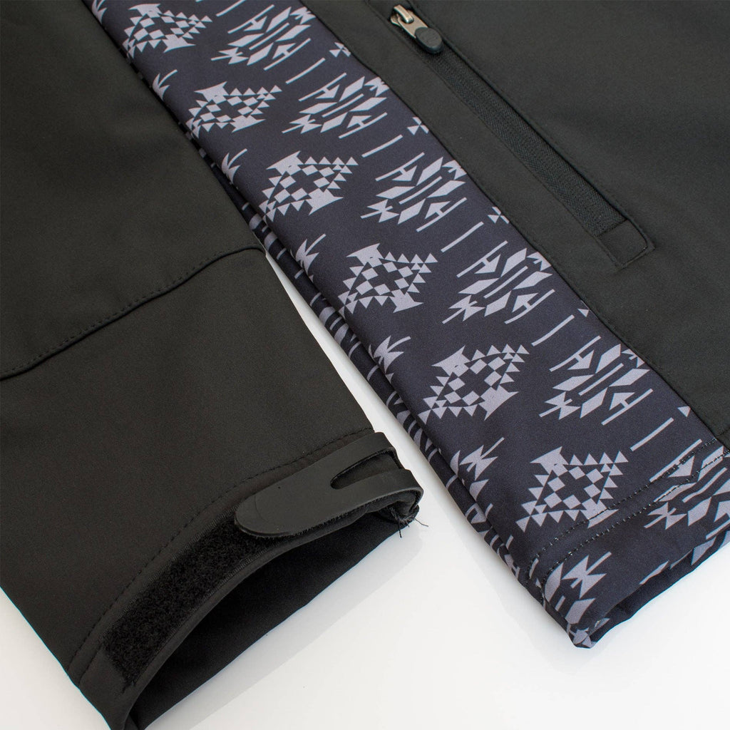 Black pants with a patterned waistband on a white background