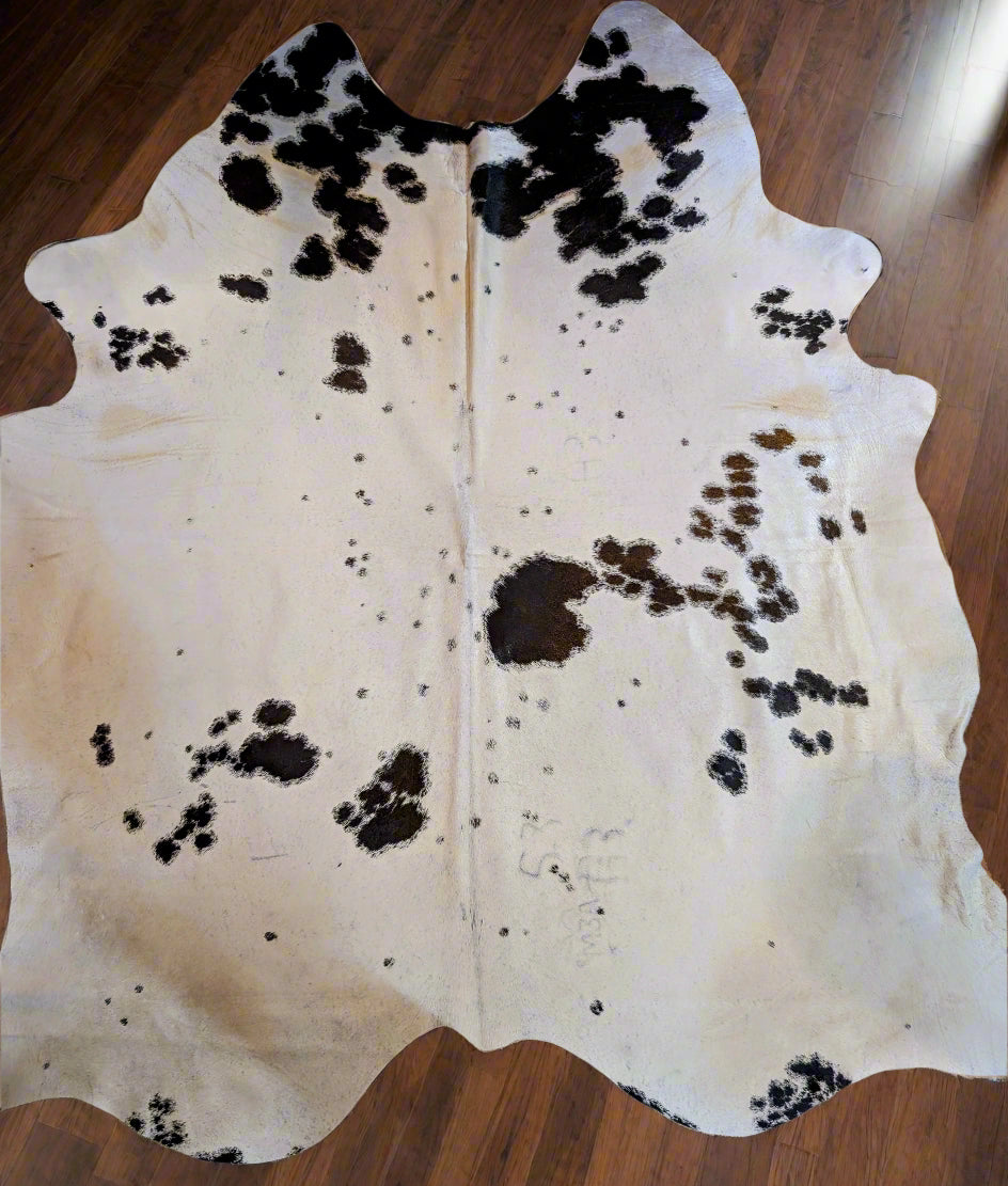 Authentic black and white cowhide with natural branding – large real cowhide rug or wall decor piece