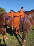 Brown horse with a leather roping saddle on 