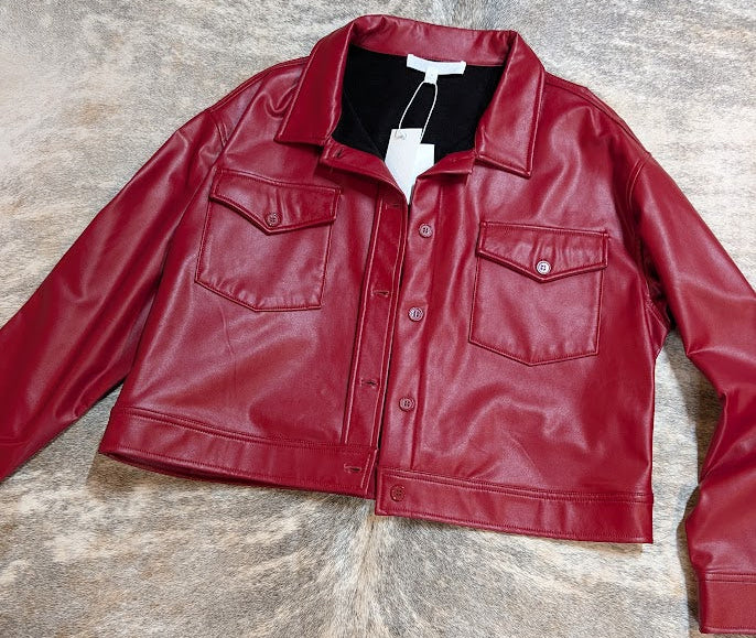 Red leather jacket on a textured gray surface
