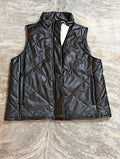 Black vegan leather vest with stitching on a brindle floor