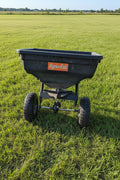 Black fertilizer spreader with 'Agri-Fab' 
