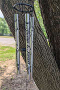 Always & Forever Windchime hanging by a tree.