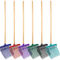 Set of colorful garden rakes with wooden handles on a white background