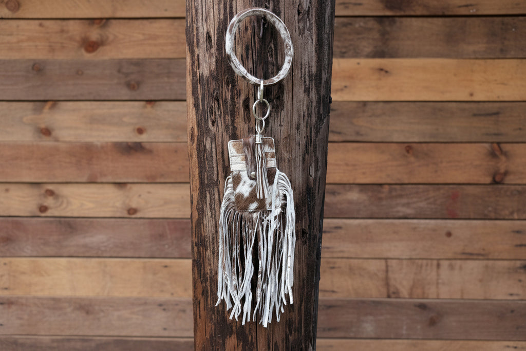Wristlet that is on a bangle with fringe that holds cards