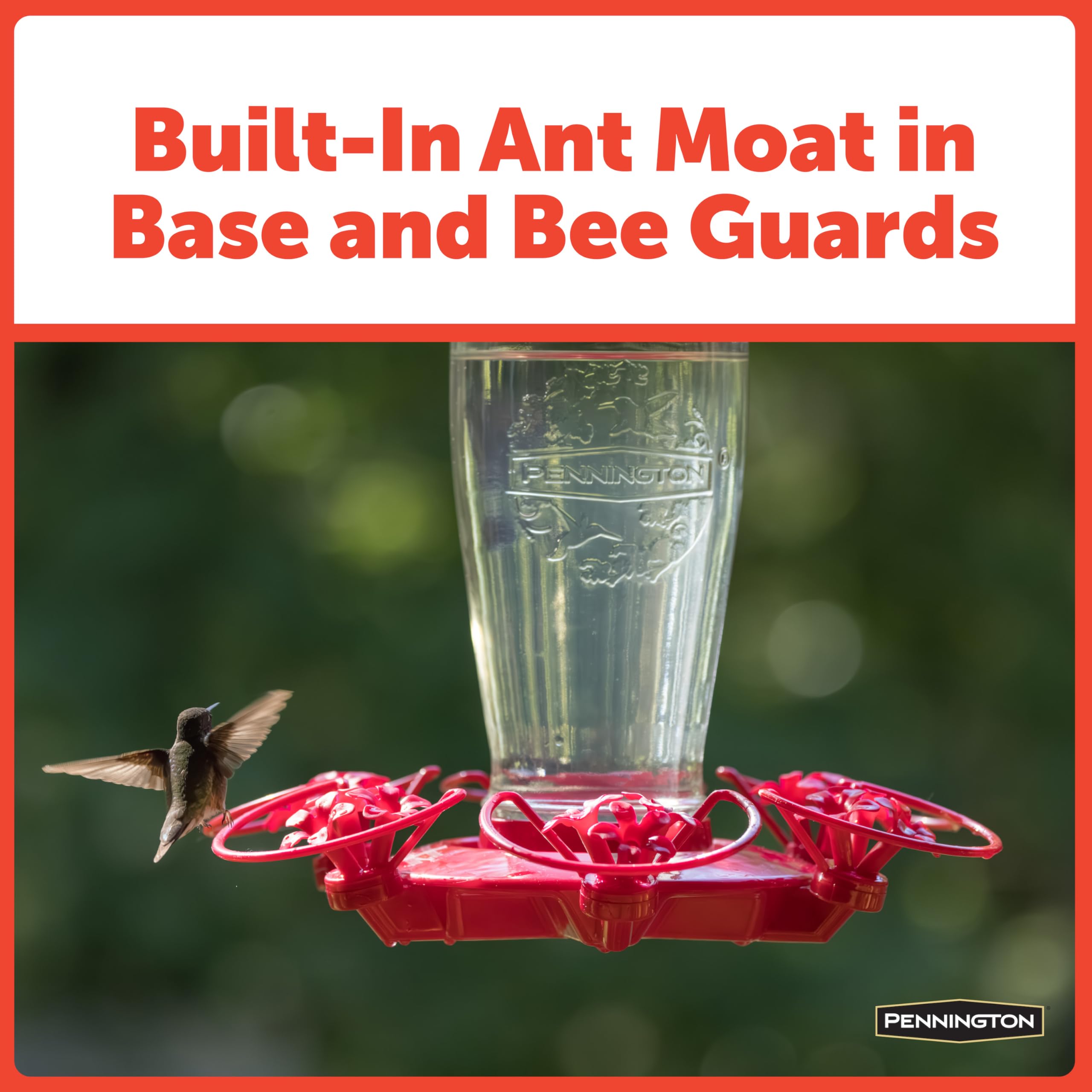 Red hummingbird feeder with a hummingbird flying around it, set against a blurred green background.