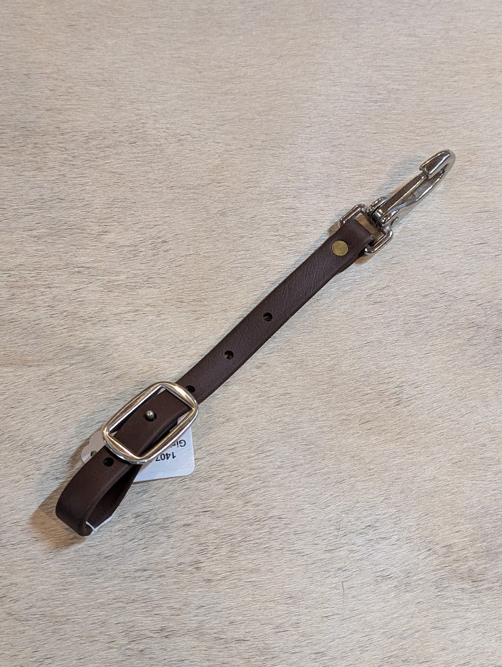 Brown Biothane Girth Connector Strap on a white surface