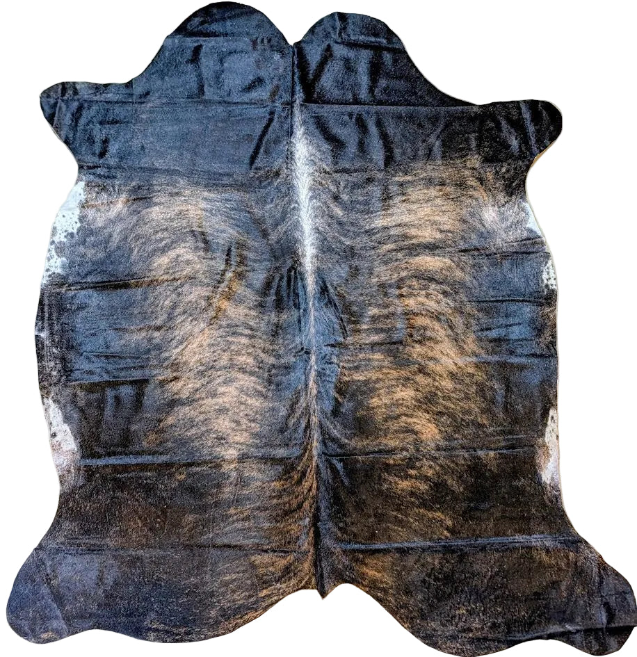 Black brindle cowhide rug with a white background.