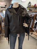 Black leather jacket with fringe on a mannequin in a store setting