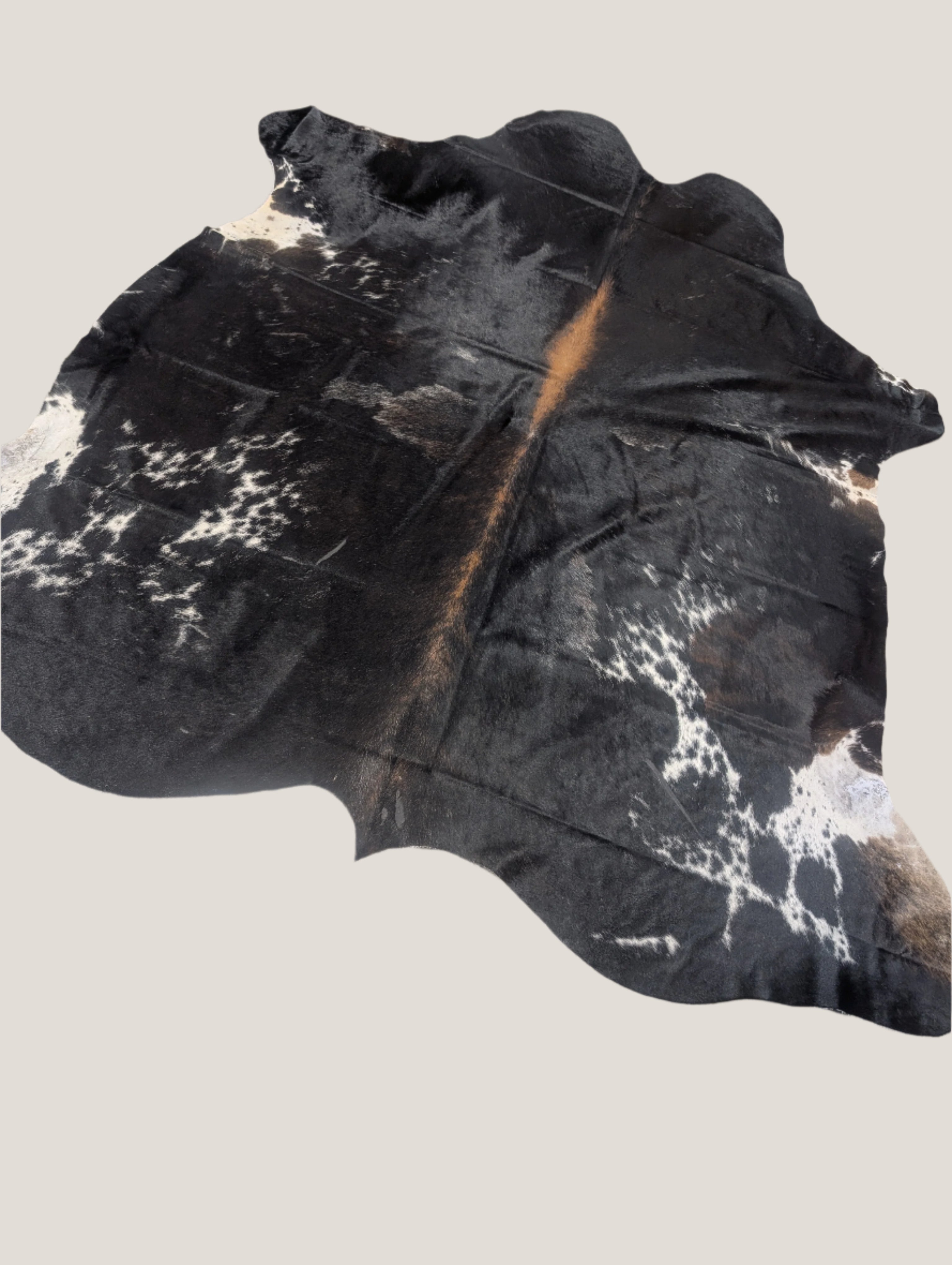 A black and white cowhide rug with natural pattern variations