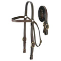 Close-up of Western tack set featuring brown leather and brass hardware rein connectors