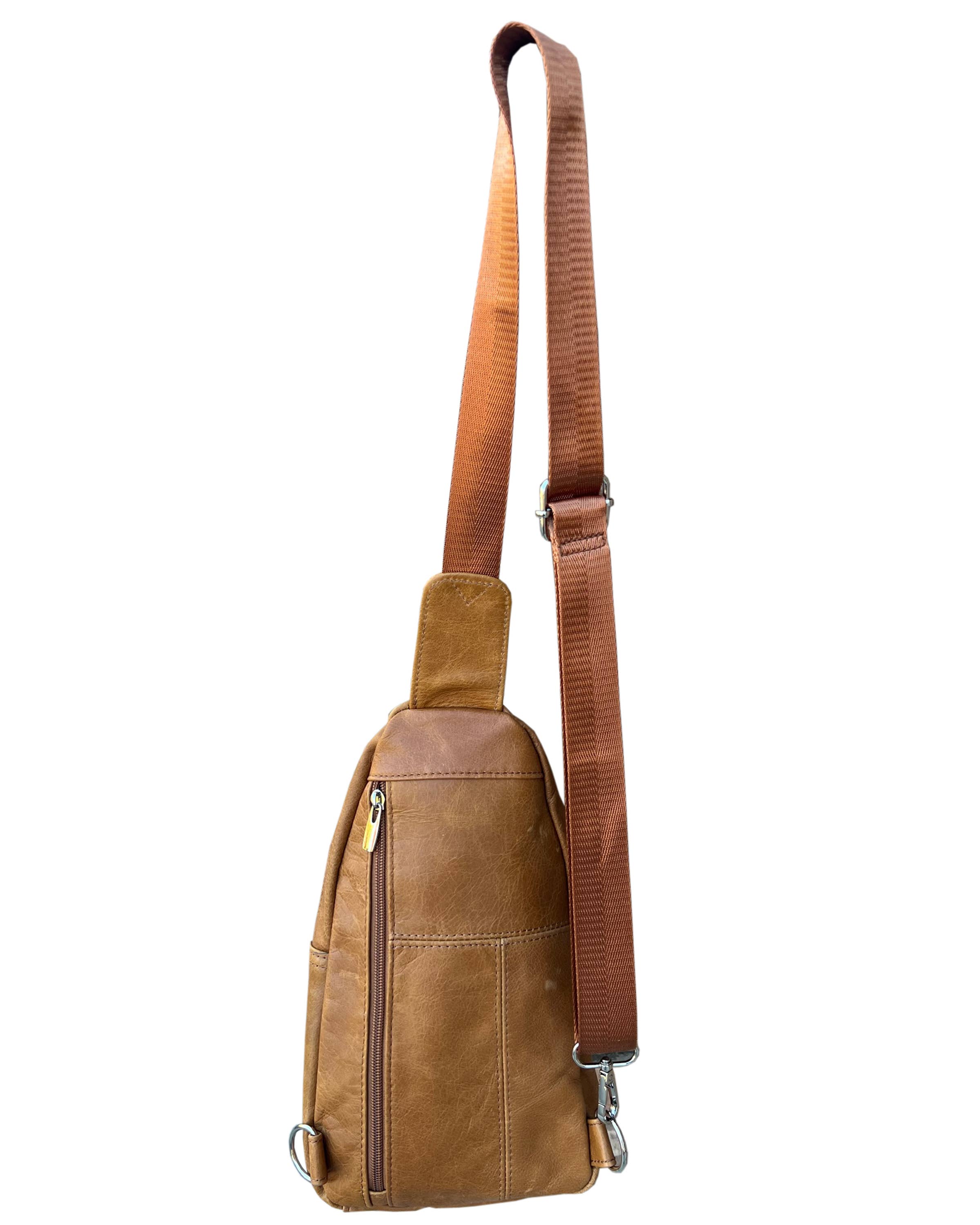 Brown leather sling bag with a strap on a white background