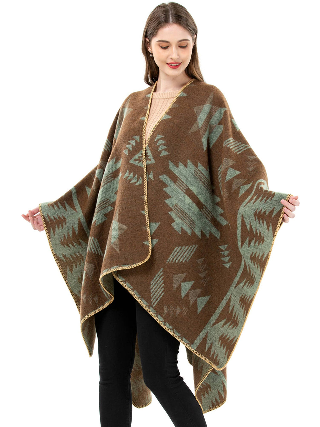 Woman wearing a brown poncho with western aztec patterns on a white background