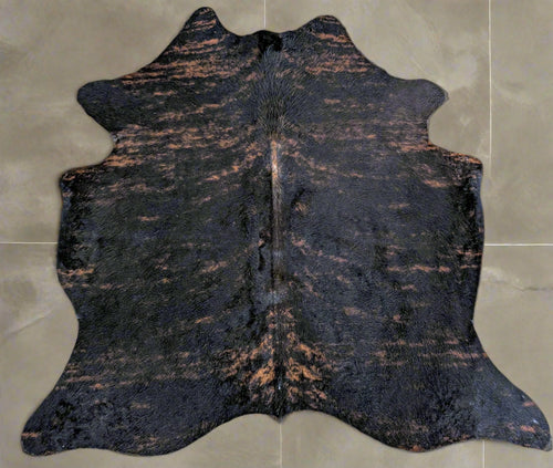 Cowhide dark brindle rug on a grey title floor