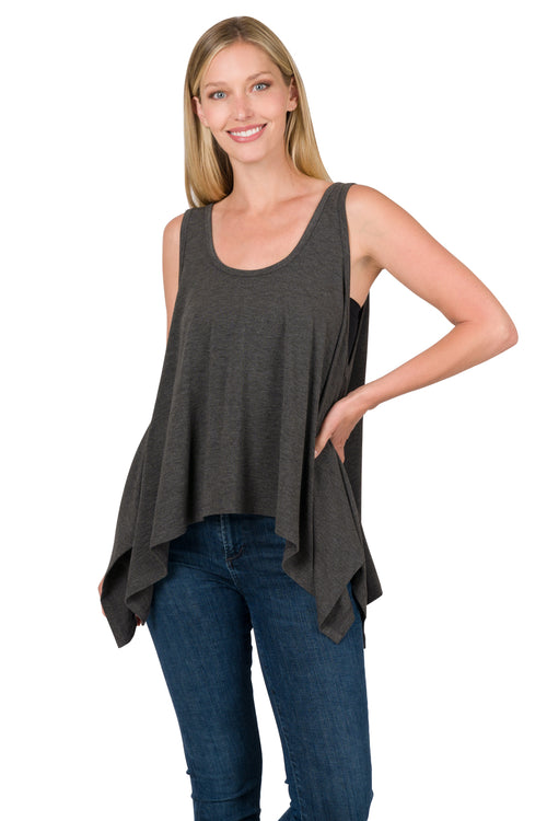Woman wearing a dark gray sleeveless top and blue jeans