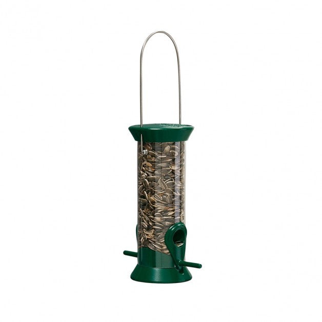 Green bird feeder filled with seeds 
