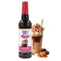 Jordan's Skinny Mixes Sugar Free Caramel Fudge Waffle Cone Syrup 750 ml bottle alongside a glass of iced coffee.